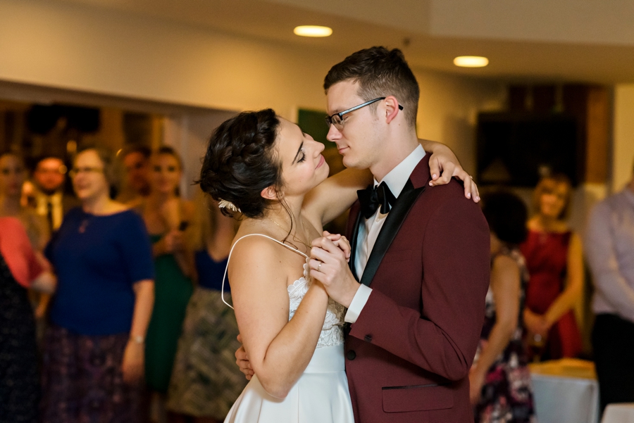 A married couple dance for the first time at their wedding reception.